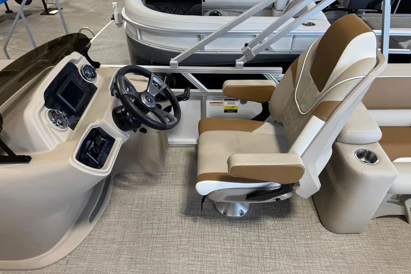 Slide: The Image of 2026 Avalon Venture 85 ELW boat interior with steering console and captain's chair. - 7