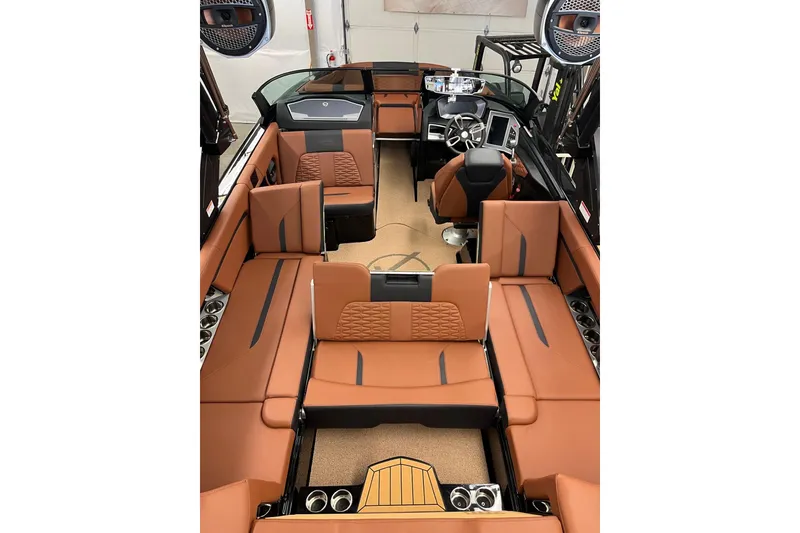 Slide: The Image of 2024 MasterCraft X24 boat interior with luxurious brown seating and modern dashboard. - 3