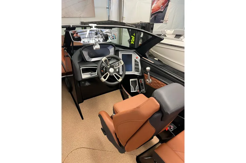Slide: The Image of 2024 MasterCraft X24 boat interior with modern dashboard and leather seating. - 5