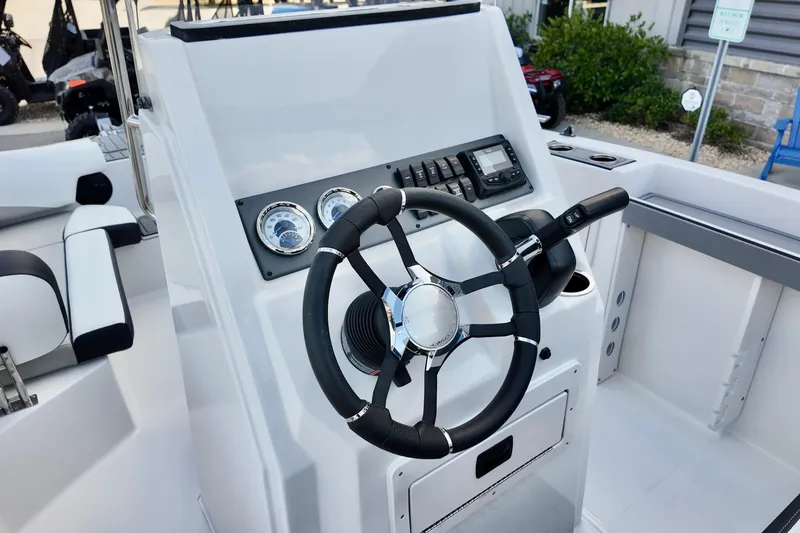 Slide: The Image of 2026 Starcraft SVX 191 OB CC boat console with steering wheel and gauges. - 10