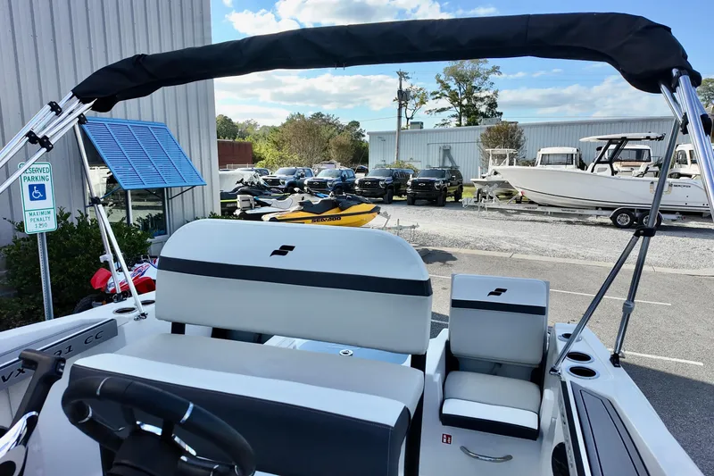 Slide: The Image of 2026 Starcraft SVX 191 OB CC boat interior with steering wheel and seating. - 7