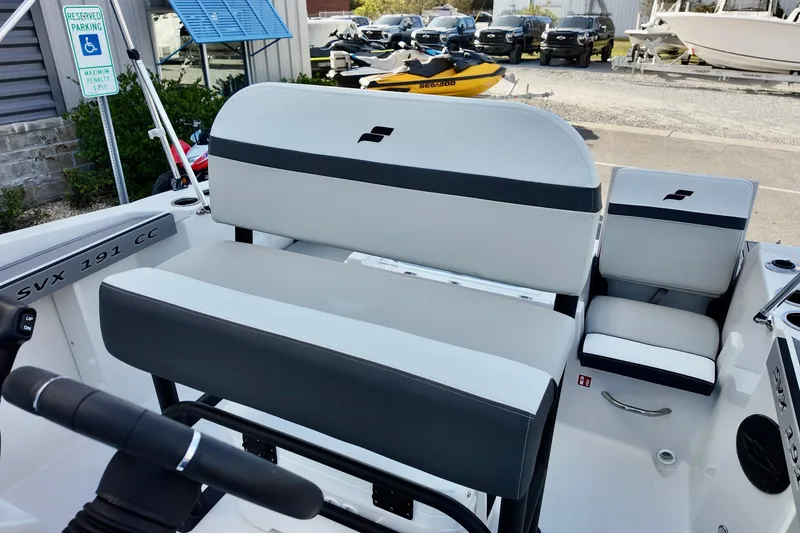 Slide: The Image of 2026 Starcraft SVX 191 OB CC boat interior with seating and steering wheel. - 9