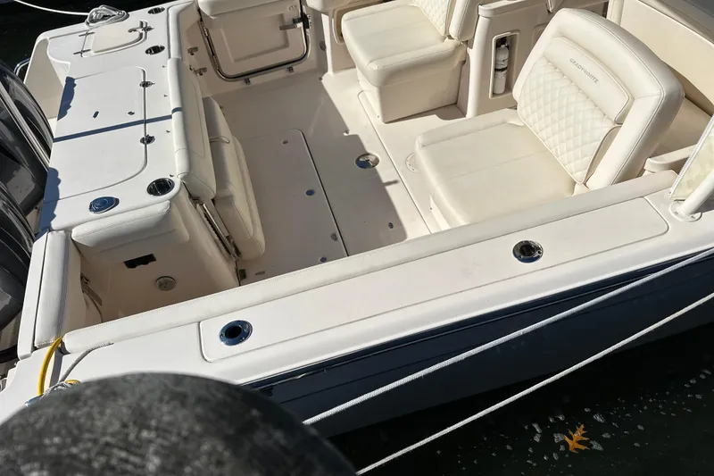 Slide: The Image of 2023 Grady-White Freedom 307 boat interior with white seating and deck details. - 18