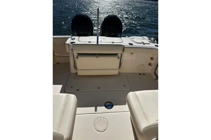 Slide: The Image of 2023 Grady-White Freedom 307 boat interior with dual engines on water. - 19
