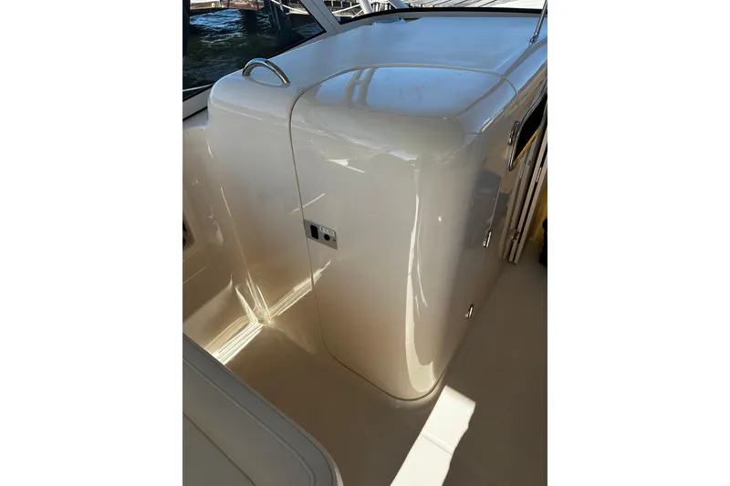 Slide: The Image of 2023 Grady-White Freedom 307 boat interior with sleek, glossy finish and modern design. - 20