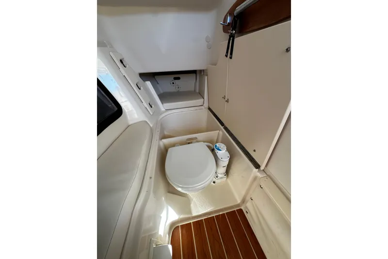 Slide: The Image of 2023 Grady-White Freedom 307 boat interior with compact marine toilet. - 21