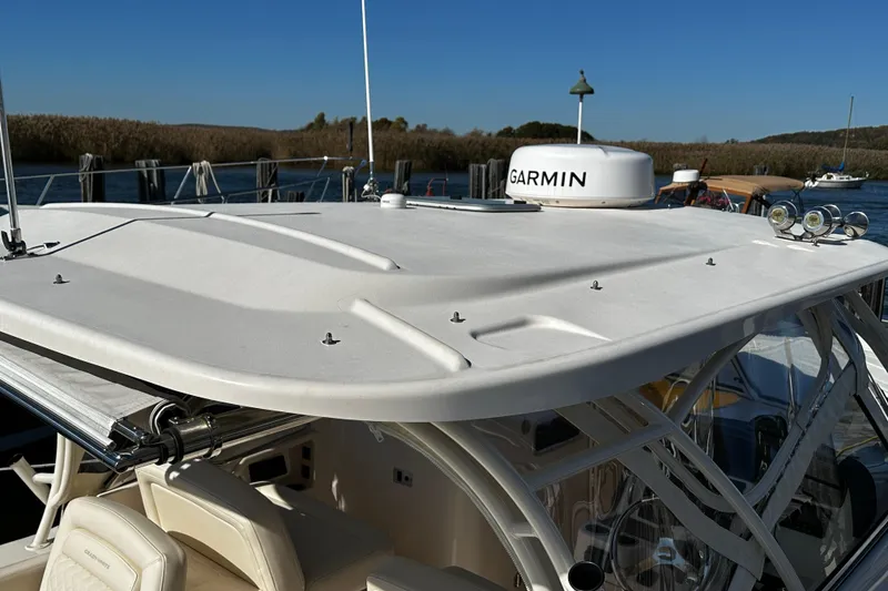 Slide: The Image of 2023 Grady-White Freedom 307 boat with Garmin radar, docked by the water. - 26