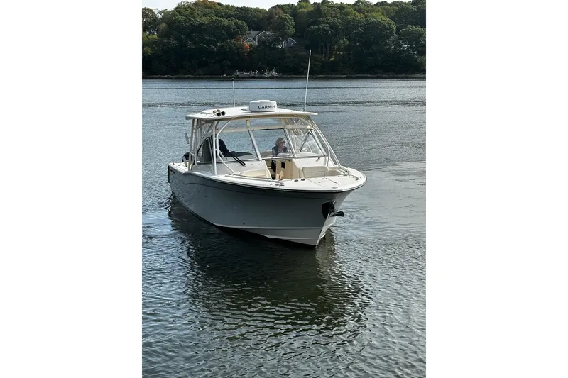 Slide: The Image of 2023 Grady-White Freedom 307 boat cruising on a calm river. - 29