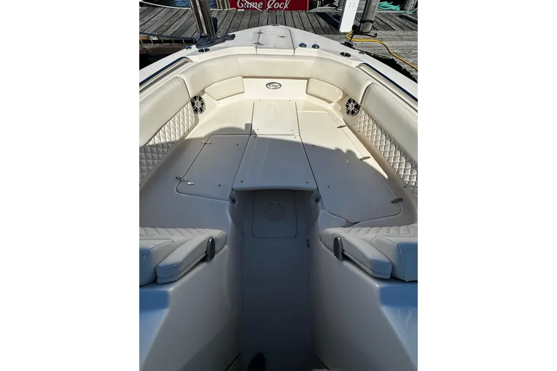 Slide: The Image of 2023 Grady-White Freedom 307 boat interior with cushioned seating and storage compartments. - 36