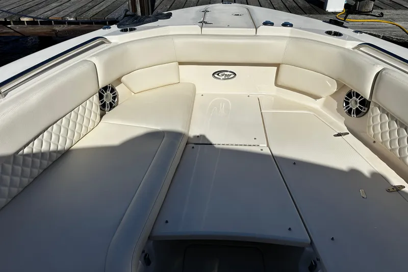 Slide: The Image of 2023 Grady-White Freedom 307 boat interior with cushioned seating and speakers. - 37