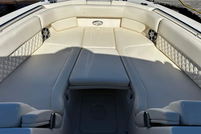 Slide: The Image of Luxurious seating area on 2023 Grady-White Freedom 307 boat, featuring elegant white upholstery. - 38