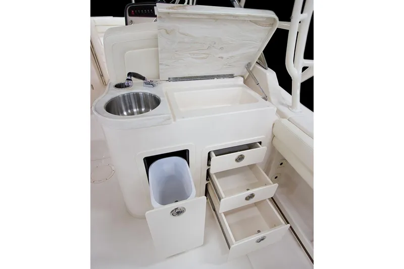 Slide: The Image of 2023 Grady-White Freedom 307 boat dashboard with steering wheel and controls. - 5