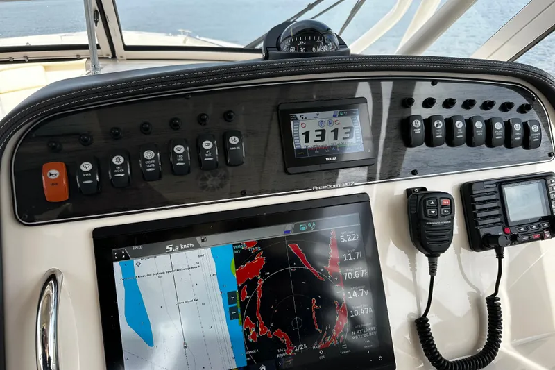 Slide: The Image of Control panel of 2023 Grady-White Freedom 307 boat with joystick and trim controls. - 8