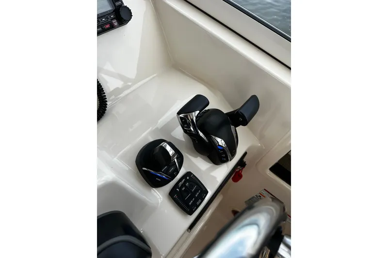 Slide: The Image of Control panel of 2023 Grady-White Freedom 307 boat, featuring navigation and power controls. - 9