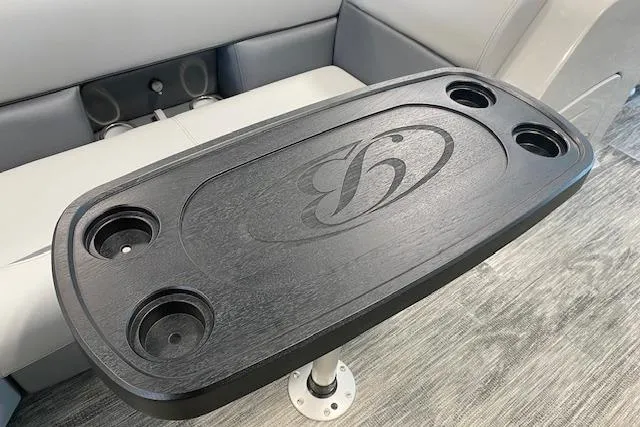 Slide: The Image of Bentley Pontoons Legacy 243 Navigator 2026, sleek table with cup holders and logo. - 12