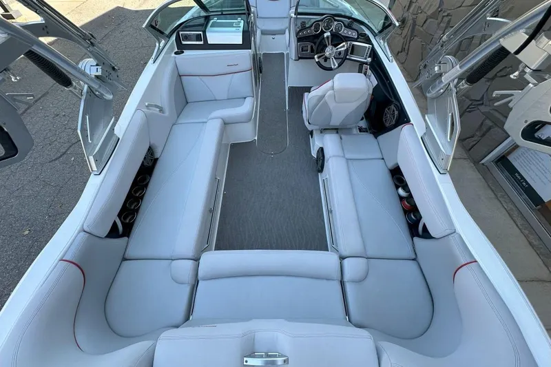 Slide: The Image of 2017 MasterCraft X23 boat interior with spacious seating and modern dashboard. - 15