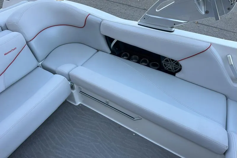 Slide: The Image of 2017 MasterCraft X23 boat interior with white seating and cup holders. - 3