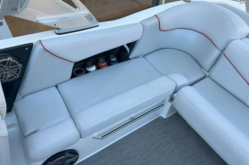 Slide: The Image of 2017 MasterCraft X23 boat interior with white seating, red accents, and cup holders. - 5