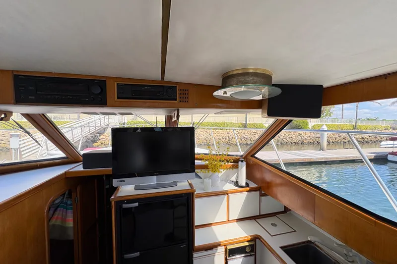 Slide: The Image of Interior of 1988 Ventare Sportfisher boat with TV, stereo, and kitchenette. - 10