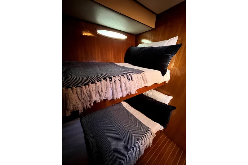 Slide: The Image of Bunk beds in 1988 Vantare Sportfisher yacht cabin with cozy blankets and pillows. - 13