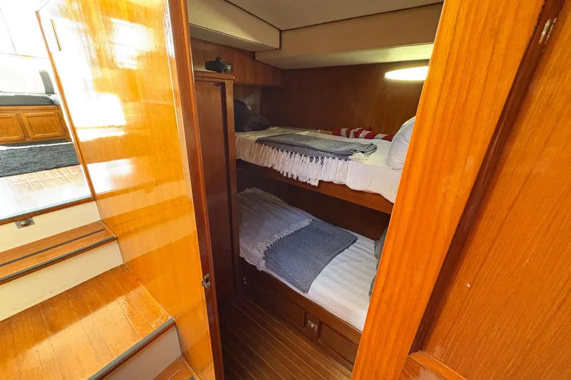 Slide: The Image of 1988 Ventare Sportfisher cabin with wooden interior and bunk beds. - 14