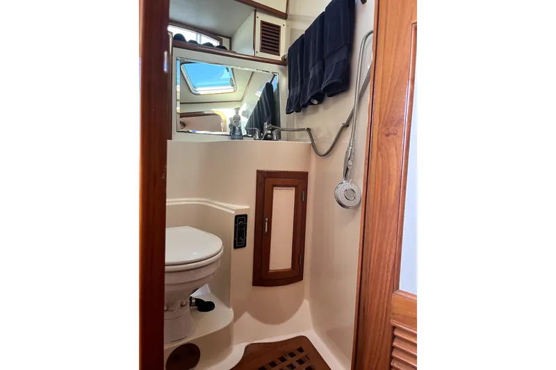 Slide: The Image of 1988 Vantare Sportfisher bathroom with wooden accents, shower, and toilet. - 16