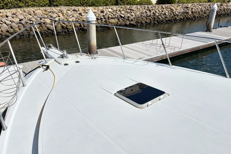 Slide: The Image of 1988 Ventare Sportfisher boat docked, showcasing sleek deck design and marina setting. - 21