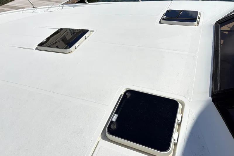 Slide: The Image of 1988 Ventare Sportfisher boat deck with hatches and sleek design. - 26