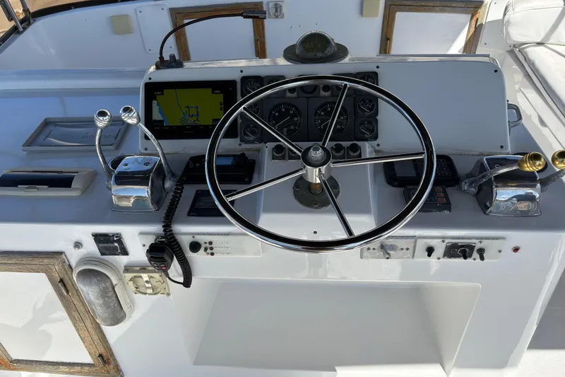 Slide: The Image of 1988 Ventare Sportfisher boat dashboard with steering wheel, controls, and navigation equipment. - 27
