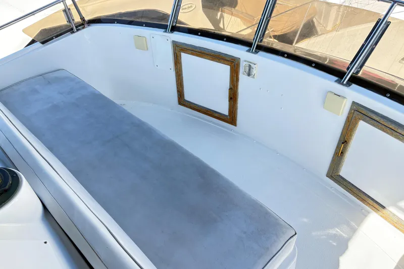 Slide: The Image of 1988 Ventare Sportfisher boat interior with cushioned seating and wooden accents. - 28