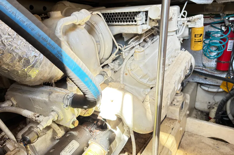 Slide: The Image of Engine room of a 1988 Ventare Sportfisher boat, featuring mechanical components and equipment. - 29