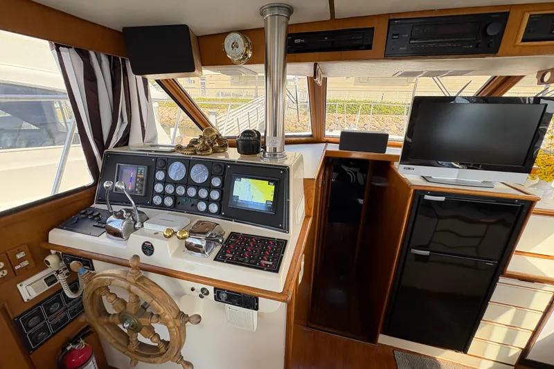 Slide: The Image of 1988 Ventare Sportfisher helm with navigation instruments, wooden wheel, and onboard electronics. - 3