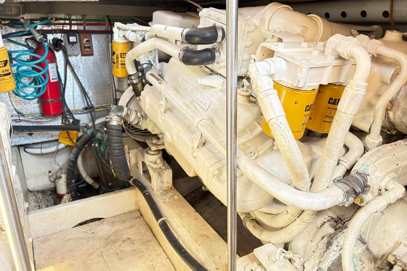 Slide: The Image of Engine room of a 1988 Ventare Sportfisher with visible CAT filters and fire extinguisher. - 30