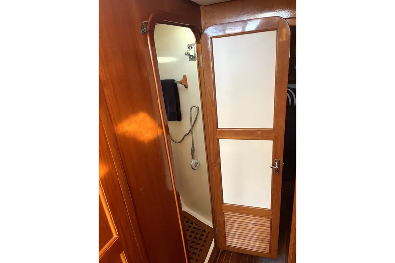 Slide: The Image of 1988 Vantare Sportfisher interior with wooden door and shower area. - 32