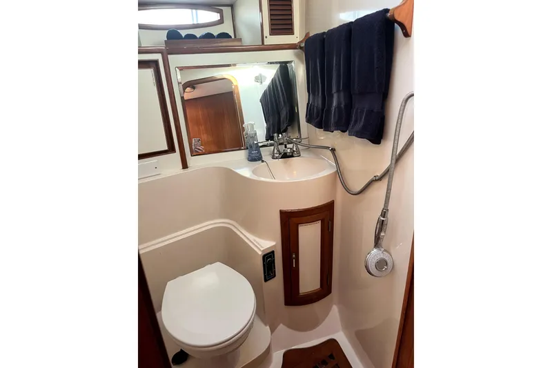 Slide: The Image of 1988 Vantare Sportfisher bathroom with sink, toilet, mirror, and showerhead. - 33