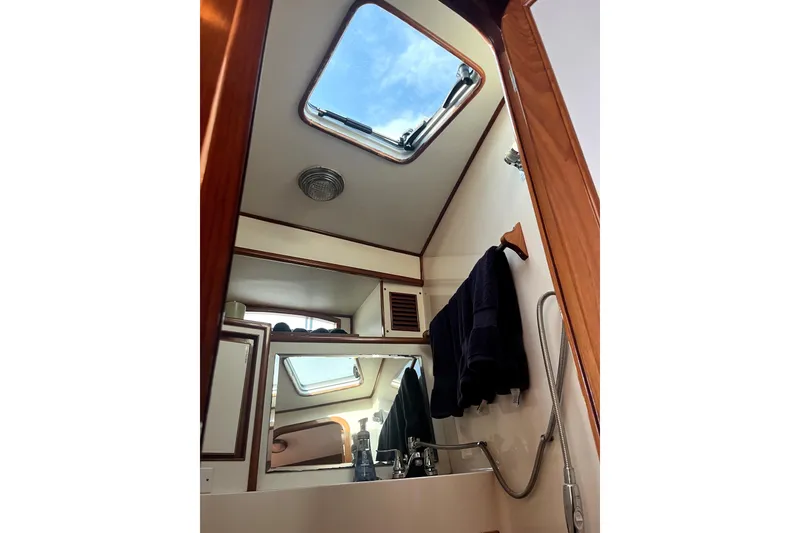 Slide: The Image of 1988 Vantare Sportfisher bathroom interior with skylight, mirror, and showerhead. - 34
