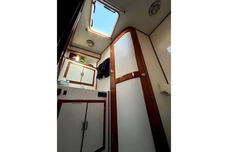 Slide: The Image of 1988 Vantare Sportfisher interior with wooden cabinets and skylight. - 35