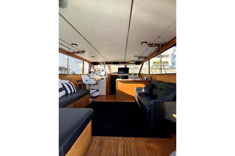 Slide: The Image of Interior of a 1988 Vantare Sportfisher boat with modern seating and navigation area. - 39