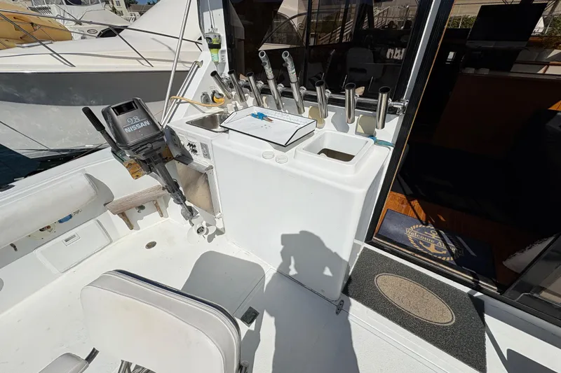 Slide: The Image of 1988 Ventare Sportfisher boat deck with fishing rod holders and Nissan outboard motor. - 4