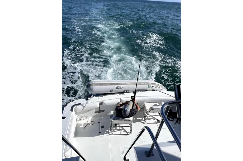 Slide: The Image of 1988 Vantare sportfisher boat with person fishing at sea, leaving a wake. - 40