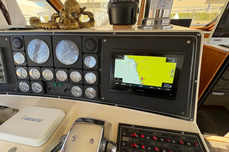 Slide: The Image of 1988 Ventare Sportfisher dashboard with gauges, navigation screen, and marine equipment. - 8