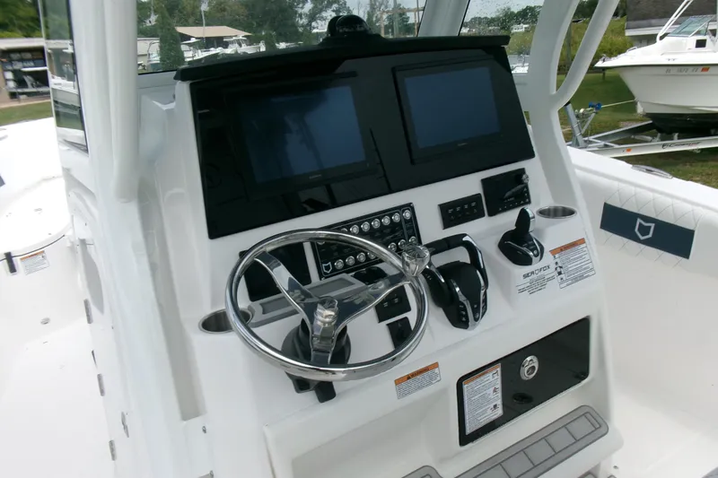 Slide: The Image of 2026 Sea Fox 288 Commander boat dashboard with steering wheel and dual screens. - 13