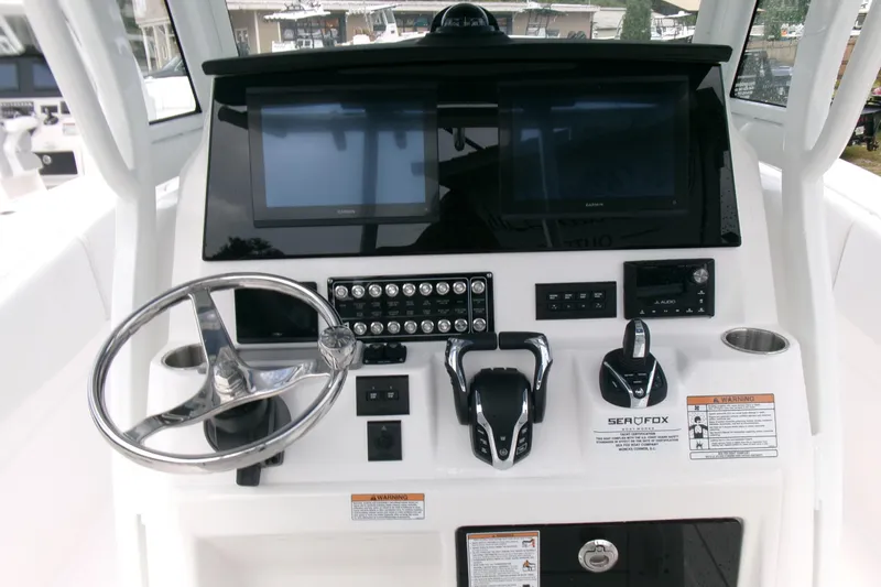 Slide: The Image of Helm of 2026 Sea Fox 288 Commander with dual screens and controls. - 16