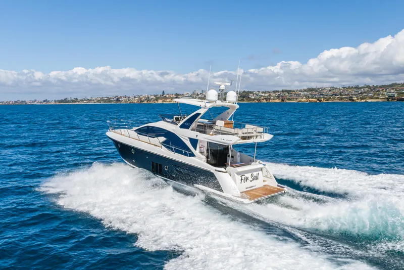 Slide: The Image of Azimut Fly 50 yacht cruising on blue ocean, 2015 model, with coastal background. - 11