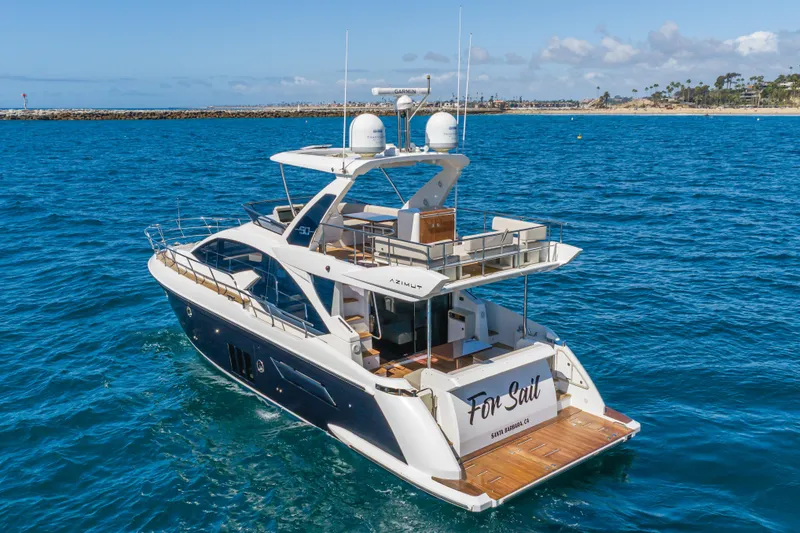 Slide: The Image of 2015 Azimut Fly 50 yacht cruising on blue ocean near coastline. - 2