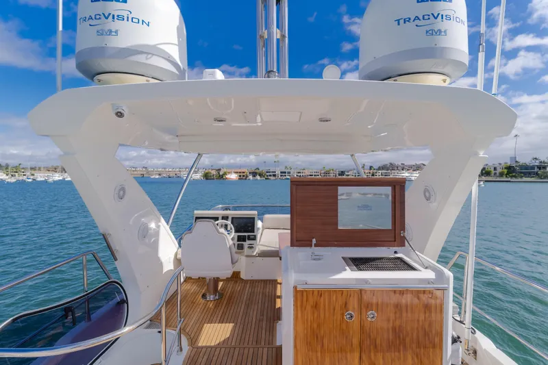 Slide: The Image of 2015 Azimut Fly 50 yacht flybridge with helm, grill, and ocean view. - 34