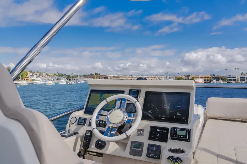 Slide: The Image of Helm of 2015 Azimut Fly 50 yacht with navigation screens, steering wheel, and ocean view. - 36