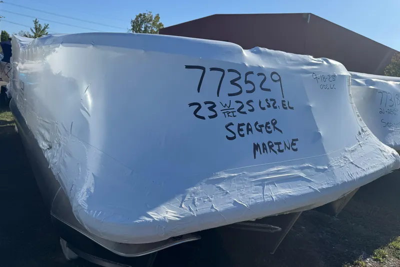 Slide: The Image of 2026 Avalon LSZ QL pontoon boat displayed in a showroom with modern interior. - 1