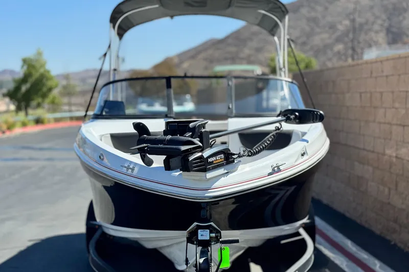 Slide: The Image of 2020 Tahoe 500 TF boat with Minn Kota motor, parked outdoors. - 2