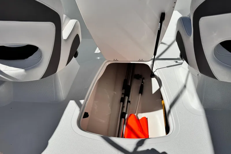Slide: The Image of Open storage compartment in 2020 Tahoe 500 TF boat, showing equipment and seating. - 22